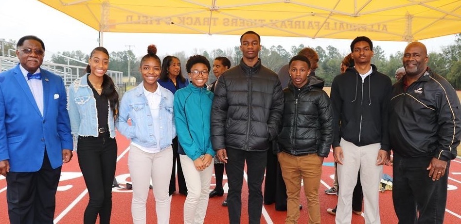 Track students pose with Rep. Lonnie Hosey and Coach Dixon
