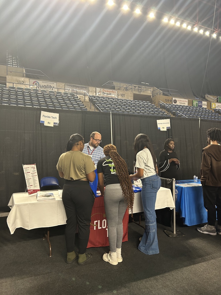 students speaking with a representative from a college