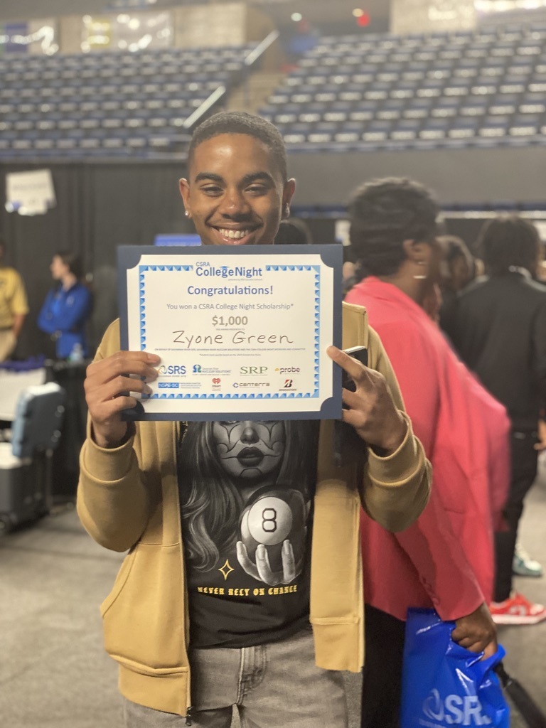 Zyone Green holding his scholarship certificate